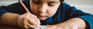 Child drawing with a pencil.