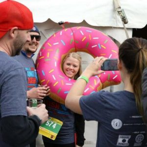 A woman wearing a donut inflatable is photographed at the Circle City Donut Dash.