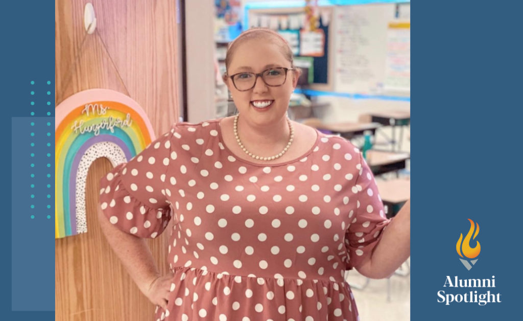 Photo of ACE alumni Morghan Hungerford standing in the open doorway of her classroom