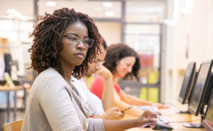 Black woman student sitting in front of a computer