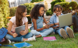 Photo of young students using technology