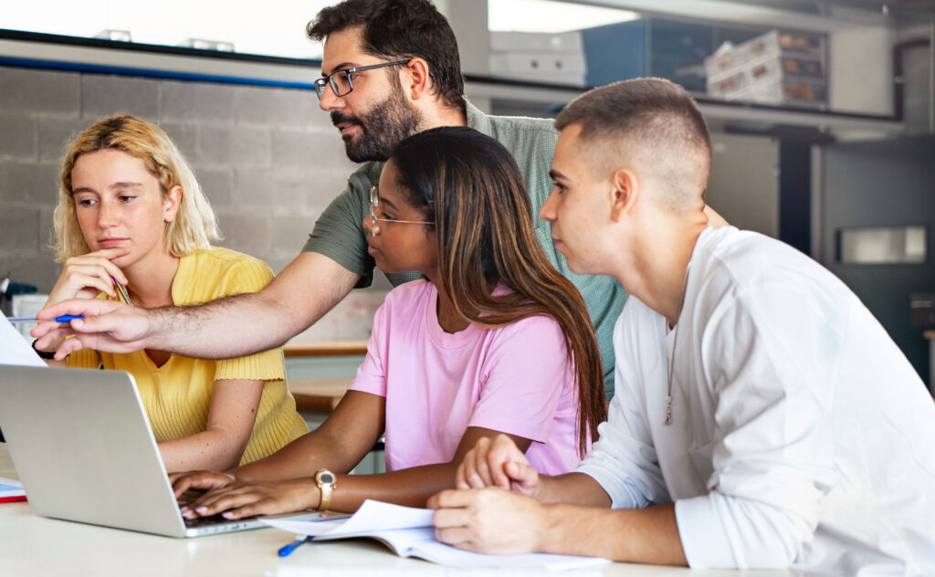 Image of teacher helping college students