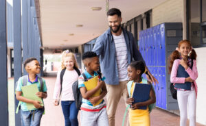 Image of administrator interacting with students