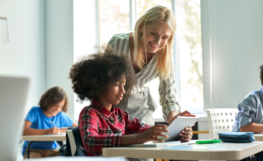 Image of teacher's aide helping a student