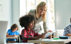 Image of teacher's aide helping a student