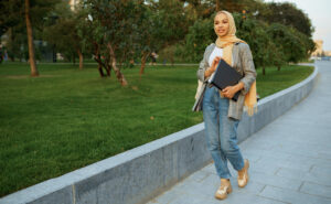 Woman taking a break from work and walking outside at a park