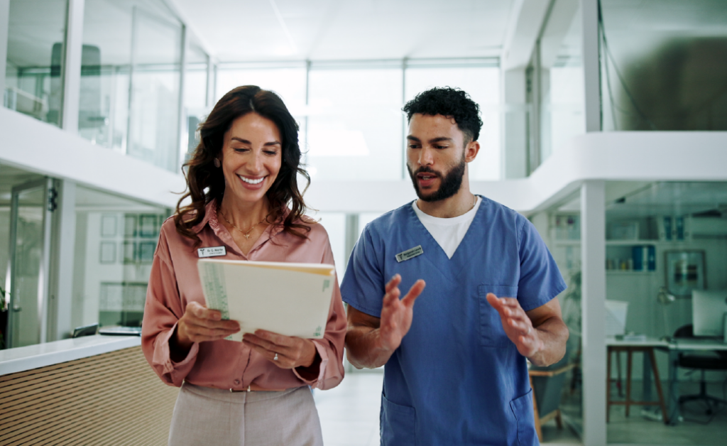 Healthcare administrator assisting a provider at a healthcare facility