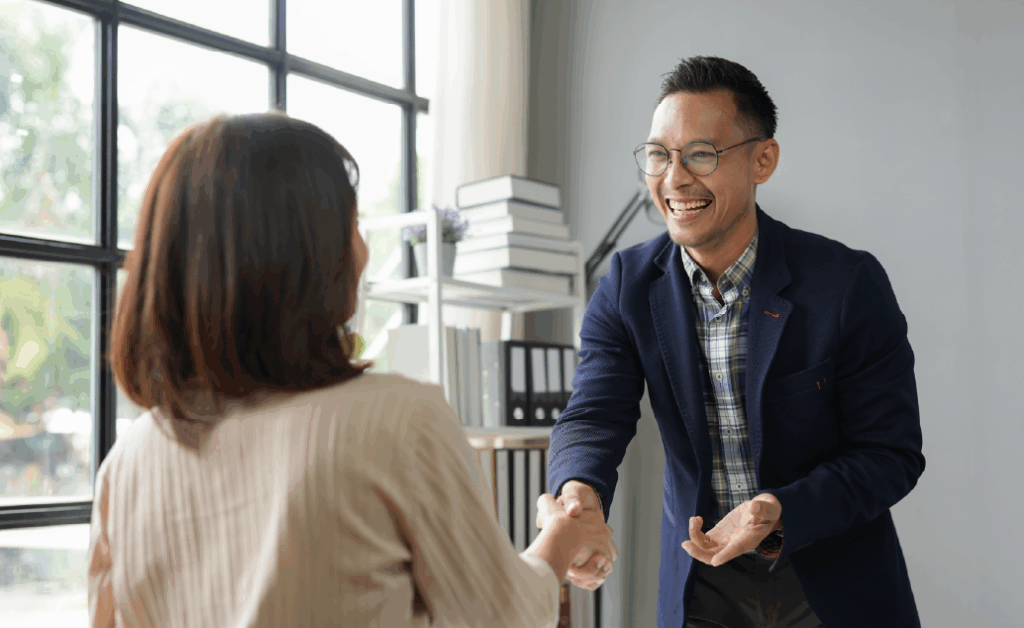 Image of job candidate shaking hands with hiring manager