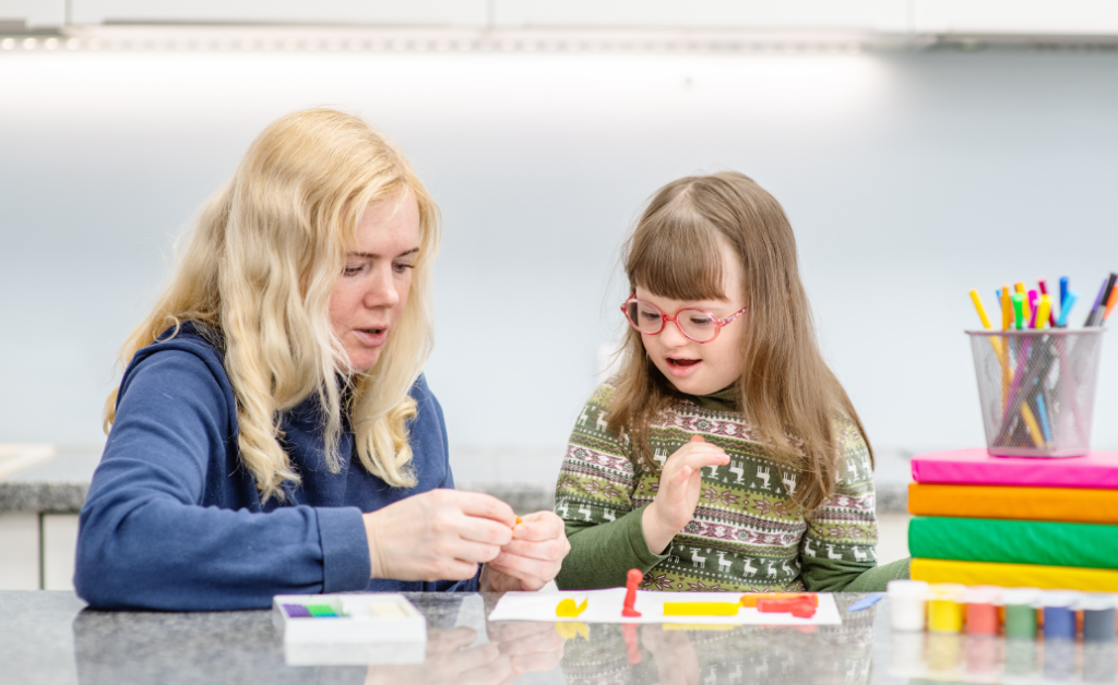 A special education teacher helping her student