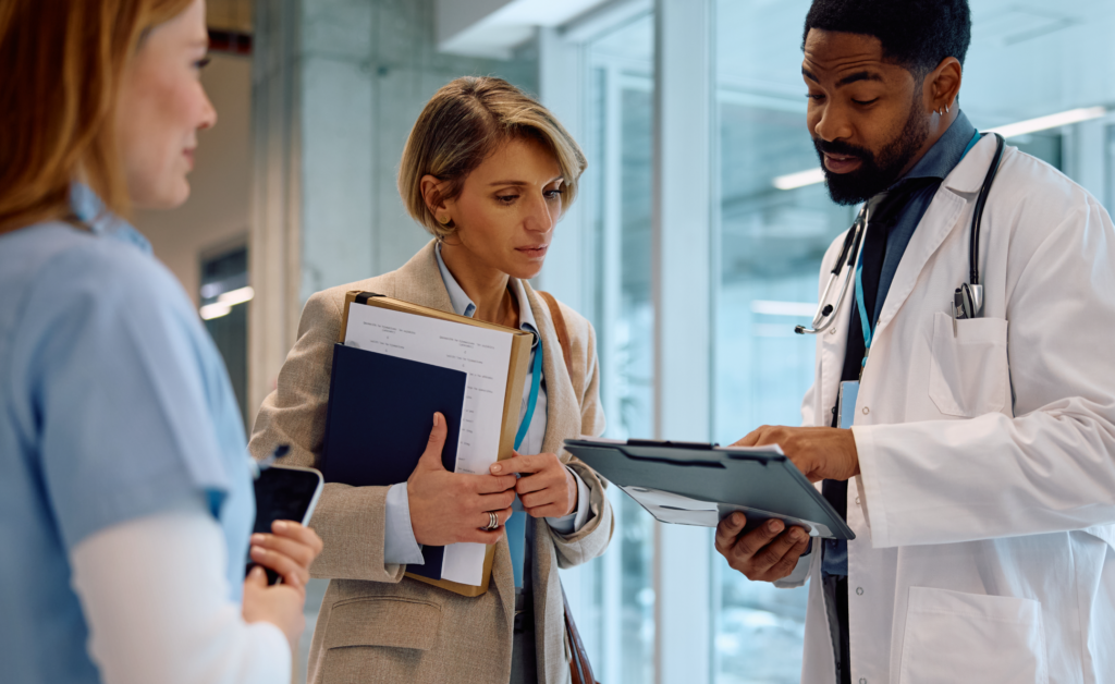 A Healthcare Consultant talking with a nurse and a doctor
